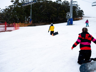 People skiing on snow in Mount Stiling Forest In Australia