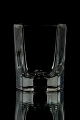 a cup for vodka on a black background.