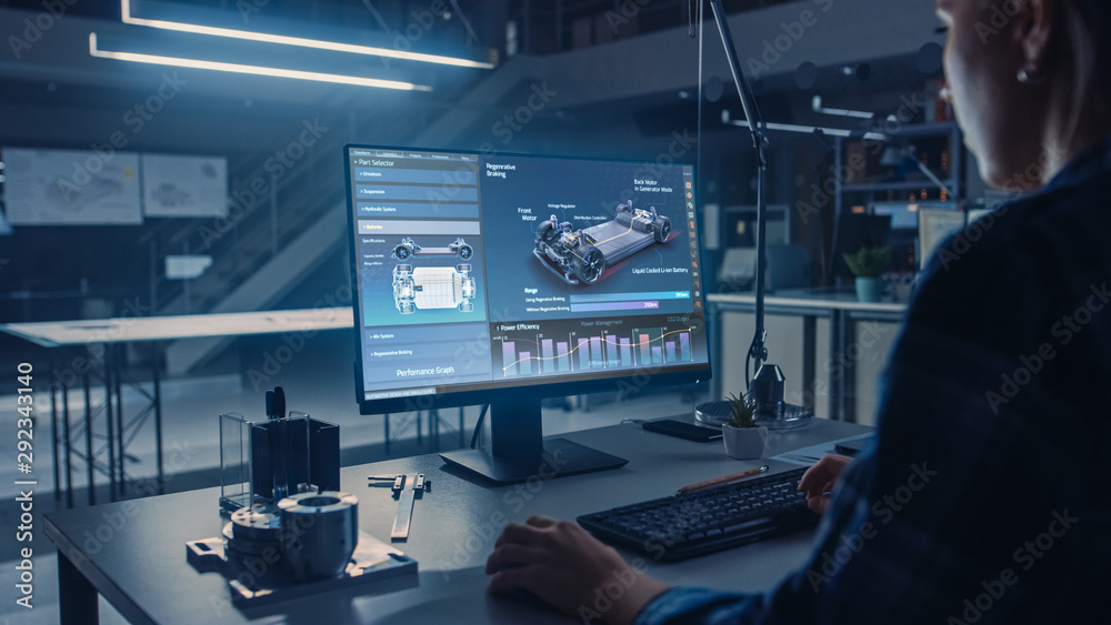 Fototapete Engineer Working on Desktop Computer, Screen Showing CAD Software with Car Efficiency and Engine Concept. Industrial Design Engineering Facility. Over the Shoulder Shot