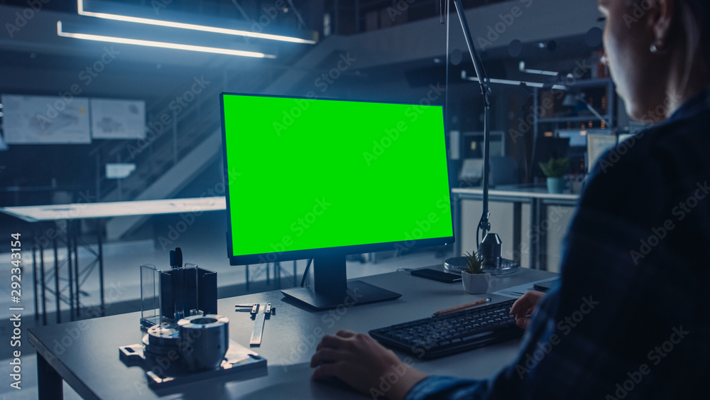 Poster over the shoulder shot of engineer working with green mock-up screen desktop computer. industrial de
