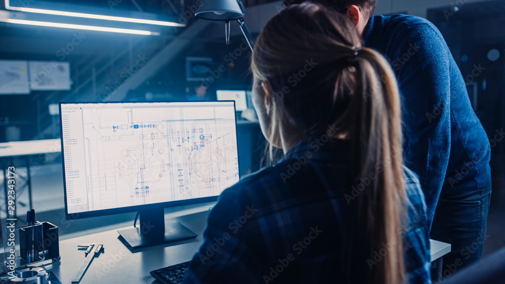 Poster Engineer Working on Desktop Computer, Screen Showing CAD Software with Technical Blueprints, Her Male Project Manager Explains Job Specifics. Industrial Design Engineering Facility Office