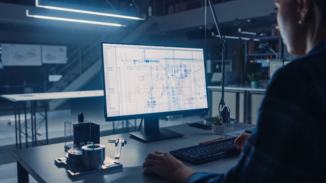 Engineer Working on Desktop Computer, Screen Showing CAD Software with Technological Blueprints. Industrial Design Engineering Facility. Over the Shoulder Shot