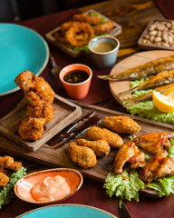 Crispy fried chicken wings, legs served with lemon and sauce
