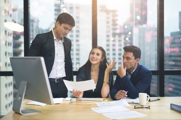 A group of business people working together in the office and joint planning.
