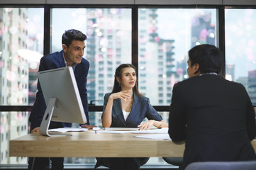 A group of business people working together in the office and joint planning.