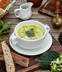 Dushbara dumpling soup served with bread on wooden table