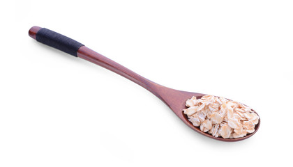 Dry rolled oatmeal in wooden spoon. Isolated on white.