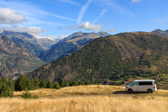 Caravelle T6 van parked on the mountain with sunrise with clouds