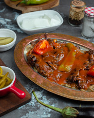 Grilled bbq steak slices with chile sauce on top of mashed aubergine