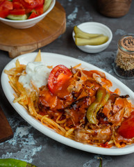 Grilled chicken with crispy shoestring potato and yoghurt