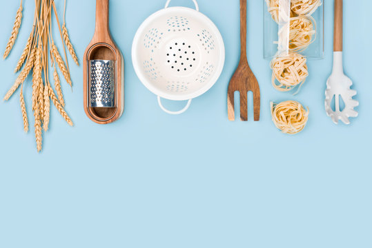 Top view of baking tools and ingredients on blue background