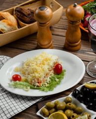 Mimosa salad with carrot, eggs, potato and cheese