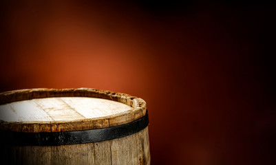 Obraz premium Wooden old retro barrel and mood brown blurred background 