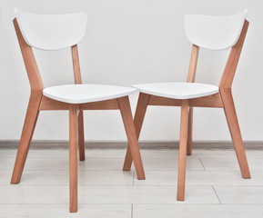 Two modern wooden chairs in the kitchen