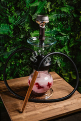 design smoky hookah for friends with milk. shisha on a green background