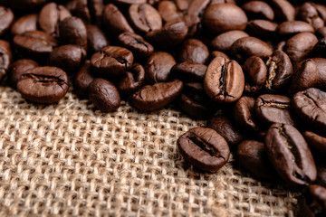 Coffee beans on burlap background