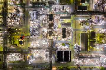 Aerial view of Oil and gas industry - refinery at twilight with chemical storage tank. Fuel and power generation, petrochemical factory industry, or environmental pollution concept