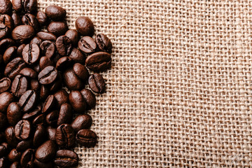 Coffee beans on burlap background
