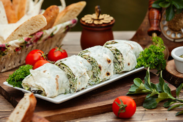 Turkish bourak layers of flatbreads wrapped with fresh herbs and cheese