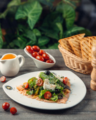 Vegetable salad with olive oil on top of the smoked salmon
