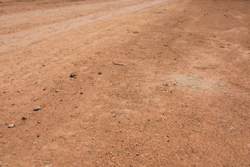 Outdoor red mud land road background closeup