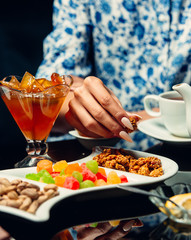 Watermelon jam in glass porcelain jar served with different sweets