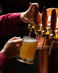 A mug of beer filled from beer tap