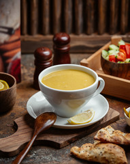 A bowl of lentil soup served with lemon