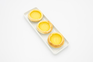 3 Chinese pastry fresh tarts neatly placed in white square ceramic dish top view isolated white
