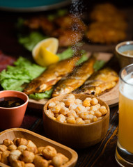 Beer setup with beer, salty boiled peas, dried smoked fish