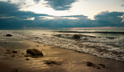 Sandy beach with stones in the early morning