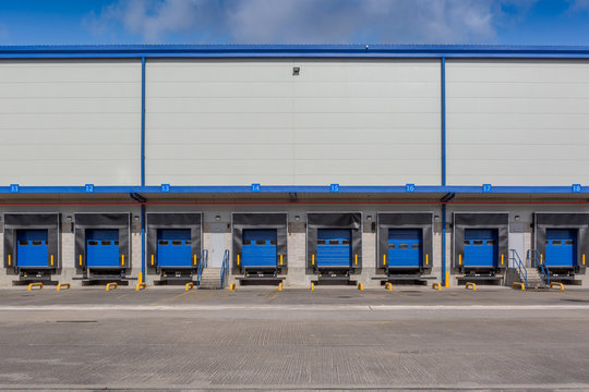 A large empty distribution warehouse with several loading bays