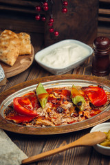 Platter of grilled bbq chicken pieces with tomato sauce on top