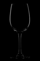 The photo shows a glass wine glass on a black background