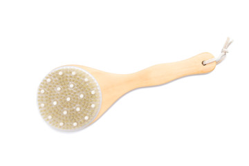 Wooden massage brush on a white isolated background, top view.