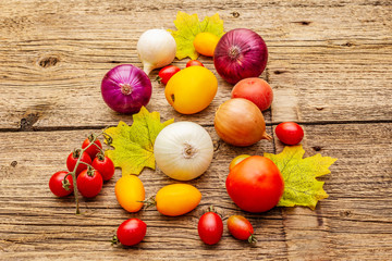 Autumn harvest vegetables cooking background. Assortment of different types onions and tomatoes