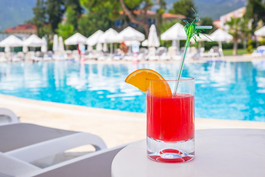 Red drink at the pool on summer holidays
