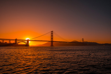 San Francisco, California / United States »; August 2019: Red sunset at the Golden Gate of San Francisco with the sun hiding on the bridge