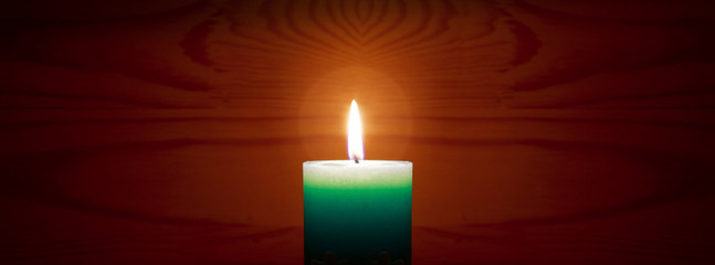 Christmas Blue Advent candle isolated on brown blur background.