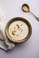 Fototapeta na wymiar Rice Kheer or Firni or Khir is a pudding from Indian subcontinent, made by boiling milk ,sugar and Rice. Served in a bowl