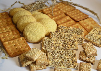 In the photo there are different delicious cookies: corn, cereal, caramel and sesame seeds.