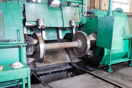 Rail wheelset in a lathe. Repair shop of railway cars