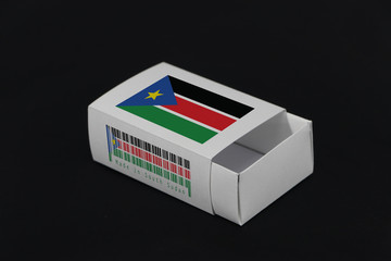 South Sudan flag on white box with barcode and the color of nation flag on black background, paper packaging for put match or products.