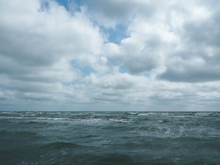 Stormy sea and sky with clouds above it