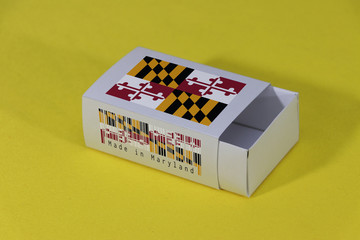 Maryland flag on white box with barcode and the color of state flag on yellow background, paper packaging for put match or products.