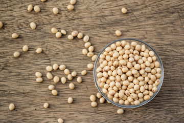 Soybeans are in a cup, placed on a wooden table with copy space