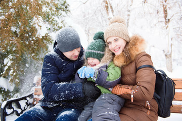 Fototapeta na wymiar Happy family takes a walk in winter walk