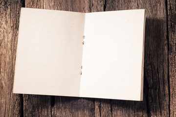 Opening blank page of vintage book on old wood background