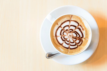 Top view of hot coffee on table / hot cappuccino with nice pattern milk foam 