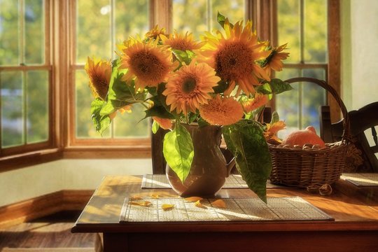 Still life with sunflowers in a vase on table